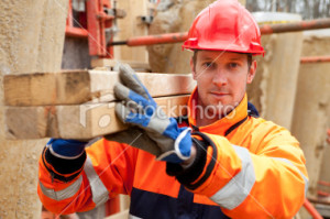 stock-photo-16156725-carpenter-smiling-at-construction-site