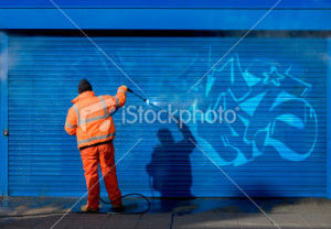 stock-photo-13517145-washing-graffiti-off-a-security-grill